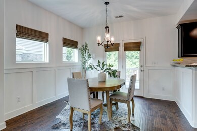 Cozy dining area between the living room & kitchen, French doors out to the deck & backyard