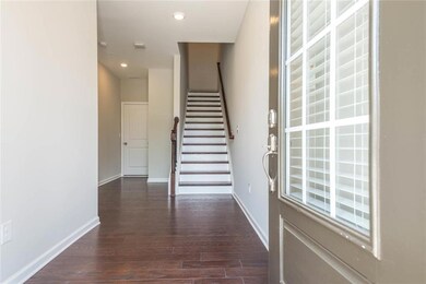 Foyer entrance featuring stairs, dark wood-style flooring, and recessed lighting