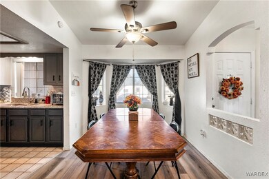 Dining area featuring ceiling fan, light hardwood