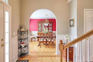 Archway from the entry, leading into the formal dining room.