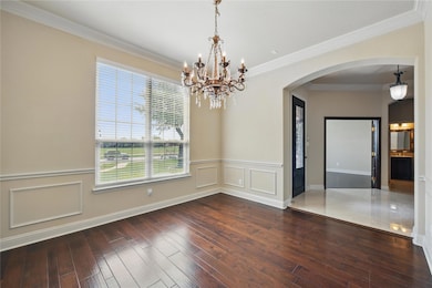 Dining room featuring a wainscoted wall, hardwood 
