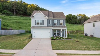 Traditional home with concrete driveway, a garage,