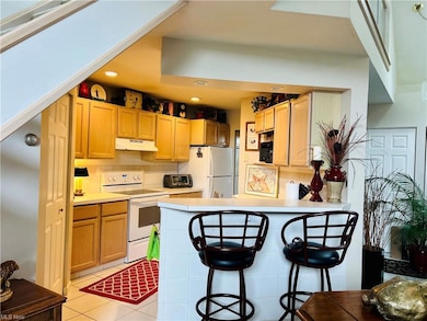 Kitchen with a kitchen island, tile floors, natura