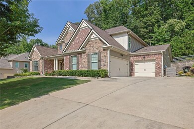 Craftsman-style house with stone siding, an attached garage, concrete driveway, and a shingled roof
