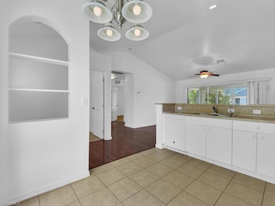 Kitchen featuring a sink, visible vents, vaulted c