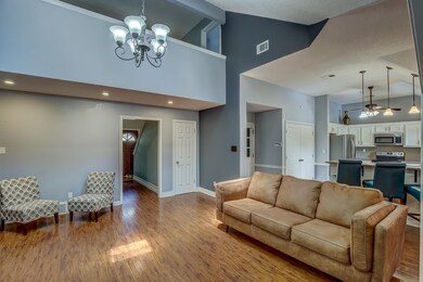 Living room with a textured ceiling, an inviting c
