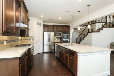 The island is large enough for 4 or 5 bar stools and also has power.