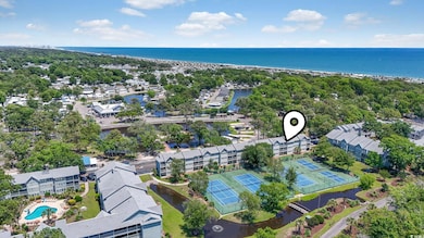 Drone / aerial view of a large body of water and a pool area