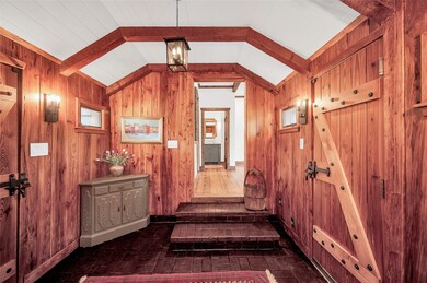Dramatic front entry with original brick flooring,