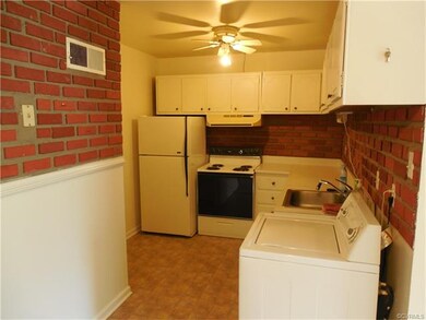 Kitchen area with refrigerator