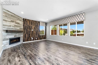 Unfurnished living room featuring hardwood / wood-