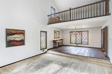 Sunken living room with vaulted ceilings opens to 