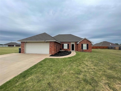 Single story home featuring a front yard and a gar