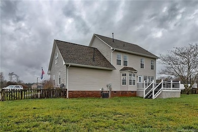 Back view of home showing deck, bay window & flagpole