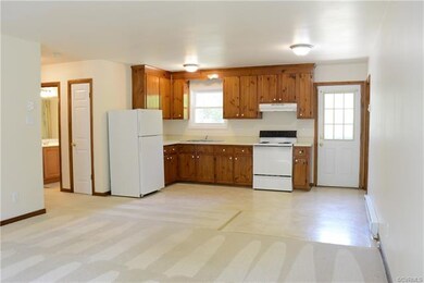 View from living room looking into an eat-in kitchen with space for dining table and chairs.