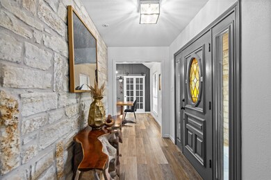 Entrance foyer featuring hardwood / wood-style fl