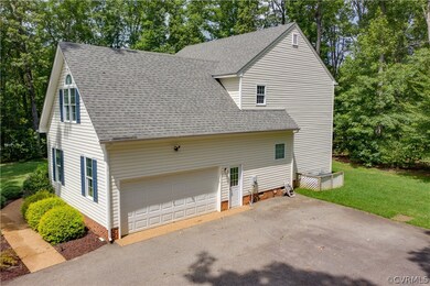 Side view with 2 car garage large paved driveway for lots of parking.