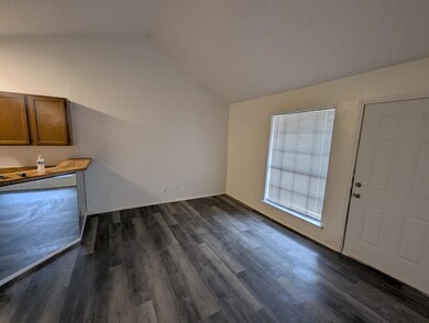Unfurnished living room with baseboards, dark wood