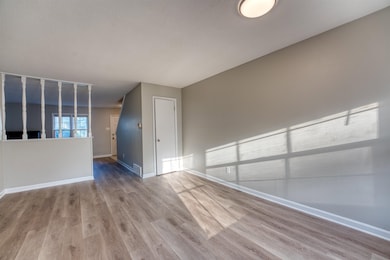 Empty room with wood finished floors and baseboards