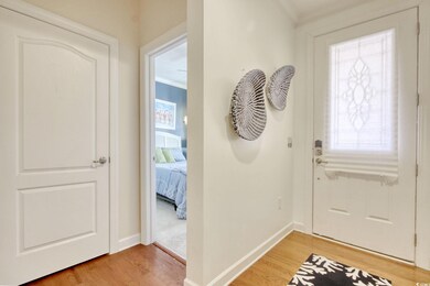Foyer entrance featuring baseboards, wood finished