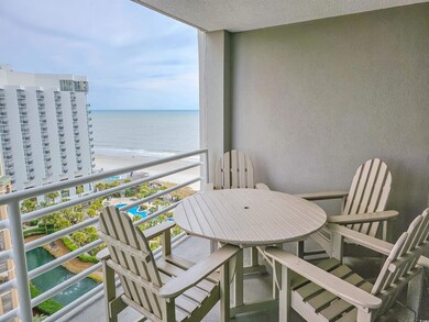 Balcony with a water view and a beach view