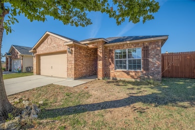 Ranch-style home featuring concrete driveway, brick siding, and an attached garage