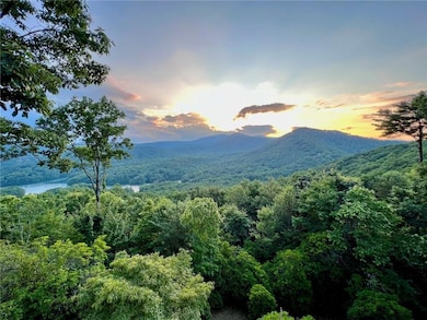 Property view of mountains with a forest view