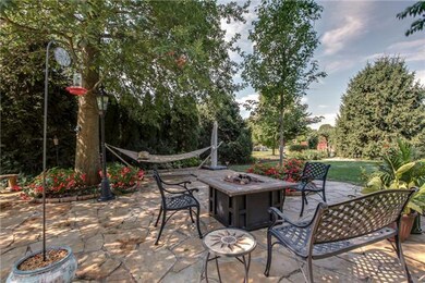 Flagstone paths meandering to the 30x20  flagstone patio create a fairy tale backyard!   Perfectly situated for a private fire, or nap in the hammack!