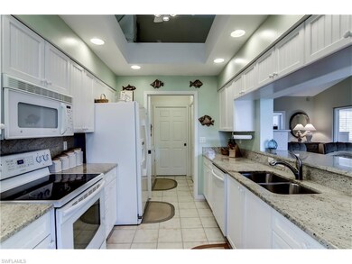 Kitchen with granite counter tops, raised bar area
