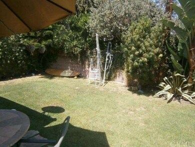 Private backyard with lush trees sorounded by bloc