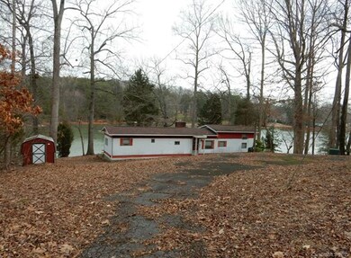 Circular paved driveway. storage shed/front of single wide. Sold AS IS- no value in trailer