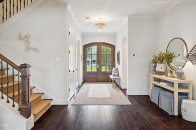 Entry hall with with engineered wood floors, reces