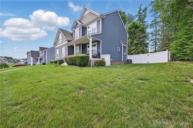 View of side of home featuring a gate, a porch, an