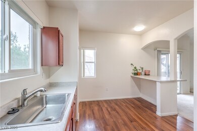 Kitchen featuring light countertops, a sink, a pen