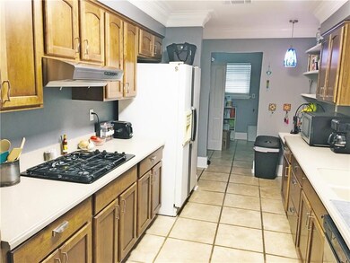 Gas stove and double ovens. Refrigerator stays.
