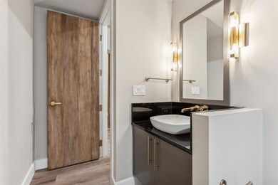 Bathroom with vanity and hardwood / wood-style flo