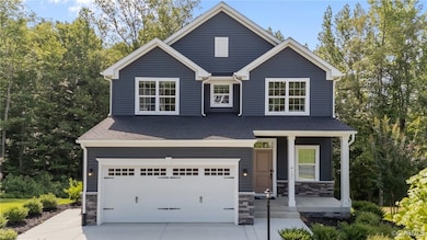 Traditional home with a garage, covered porch, con