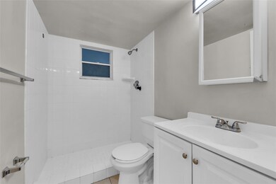 Bathroom with walk in shower and white vanity