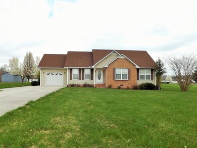 Huge front yard with mature trees, curbed landscaping & concrete drive.