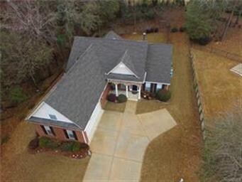 Beautiful home is surrounded by woods. Lot extends