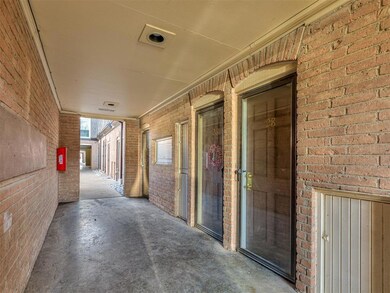 Hall with brick wall and concrete floors