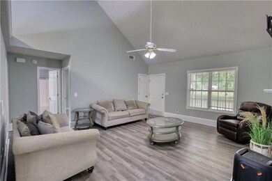 Living room featuring high vaulted ceiling, a ceil