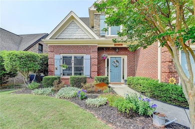 View of front facade with brick siding, central AC, and a front yard