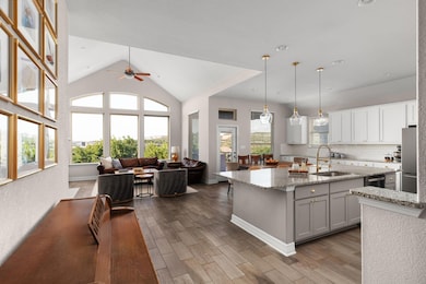 Kitchen with open floor plan, a ceiling fan, a ki