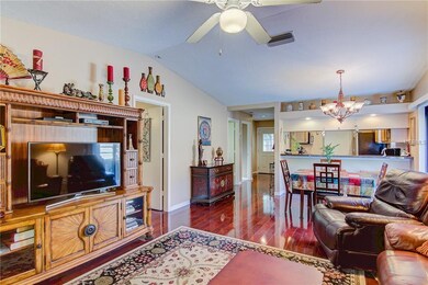 High Ceiling Living room looking to Front Door and Kitchen Counter. Gotta love the floors!