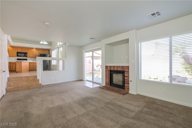 Unfurnished living room with light colored carpet and a fireplace