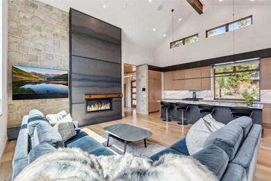 Open floor plan looking into kitchen with vaulted