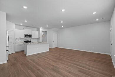 Kitchen with stainless steel appliances, a sink, r