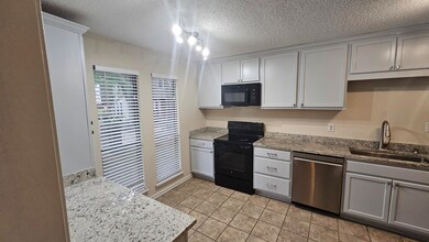 Kitchen featuring light tile patterned floors, a t