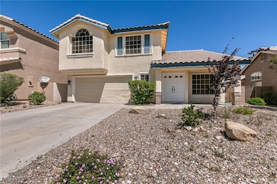 View of front facade featuring a garage, stucco si